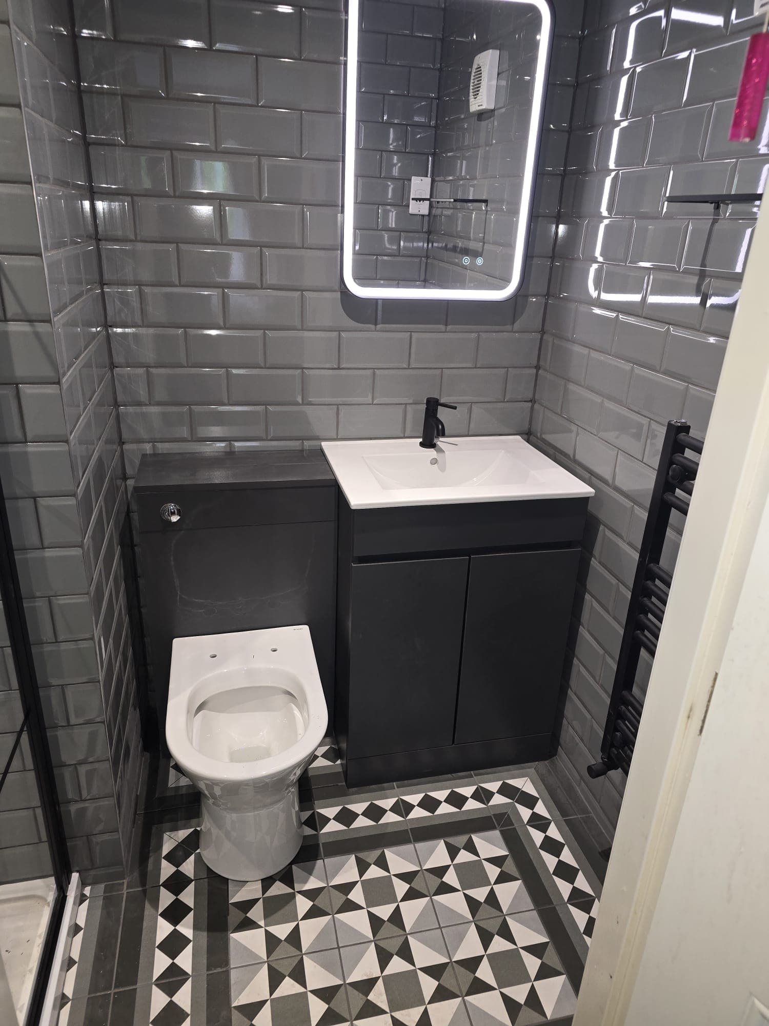 Complete bathroom installation with toilet and vanity unit by Greenside Joinery
